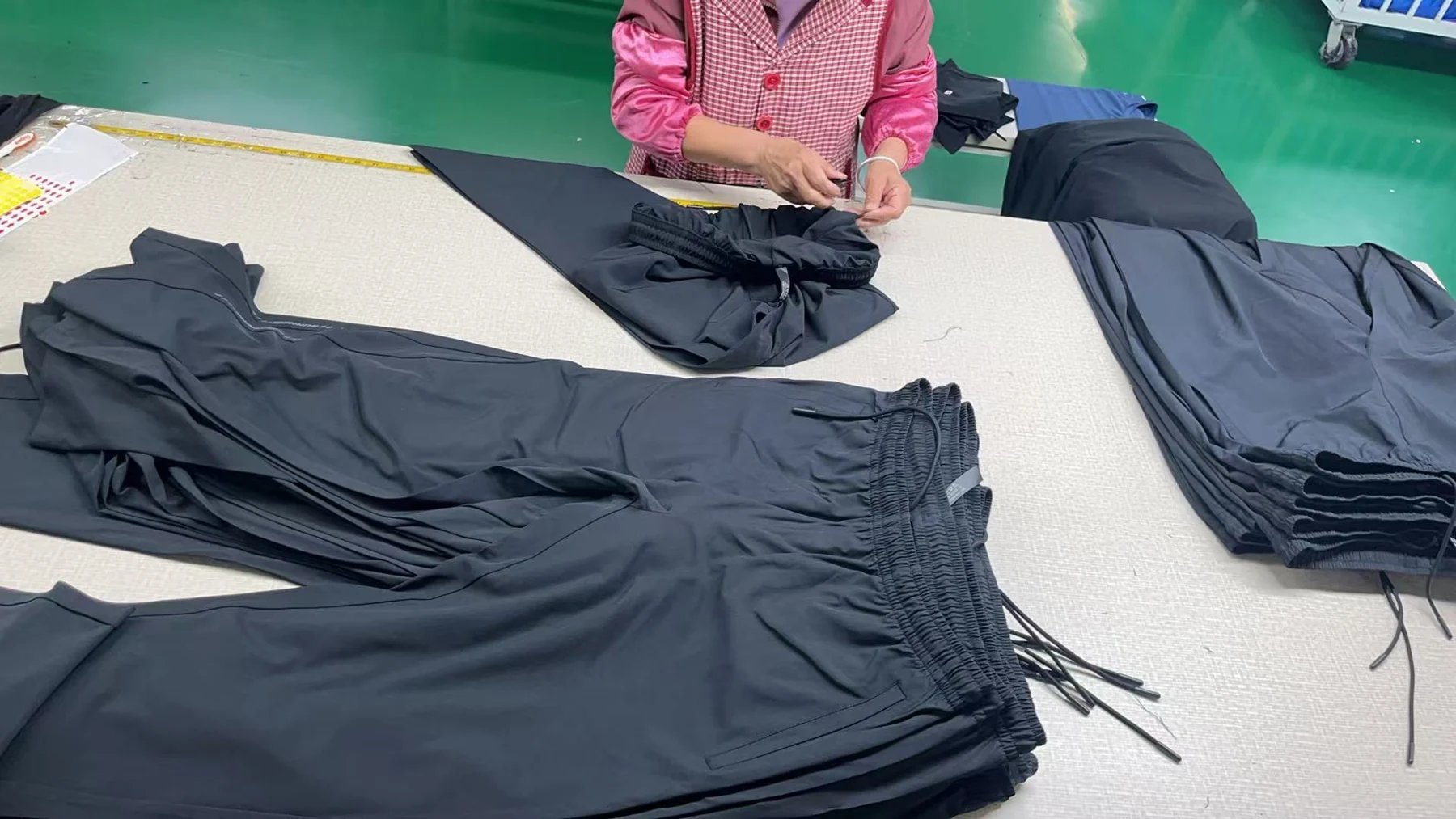 Finished garments checked at a worktable